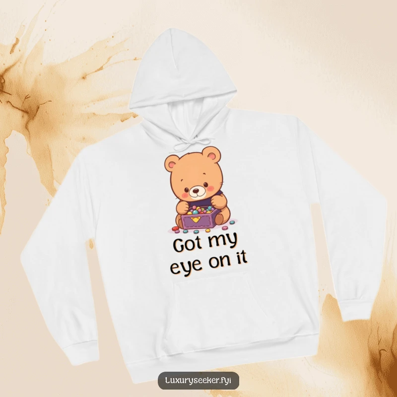 Funny Bear Hoodie depicting a curious bear captivated by a tiny, overflowing jewelry box full of shiny, precious gems.