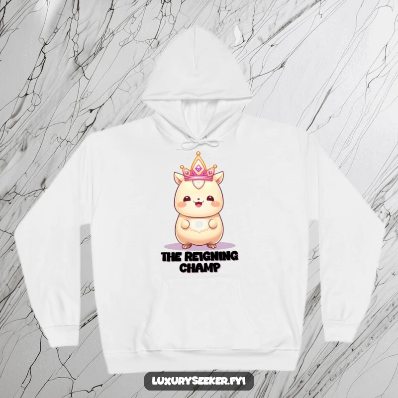 Funny hoodie featuring a gleaming creature with a proud smile admiring a sparkling, tiny crown, offering warm and humorous regal comfort.