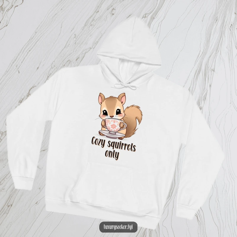 Funny squirrel hoodie featuring a curious squirrel with a tiny ornate teacup and saucer, offering warmth and delightful humor.