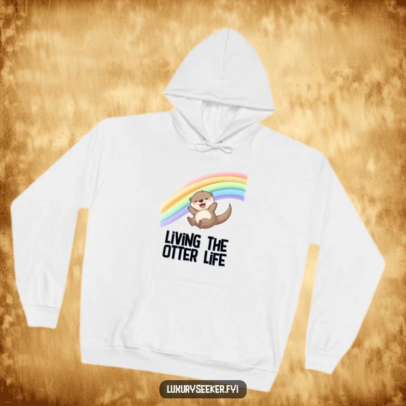 Funny Otter Hoodie featuring a joyful otter sliding down a shimmering silk ribbon rainbow, offering comfort and playful charm.