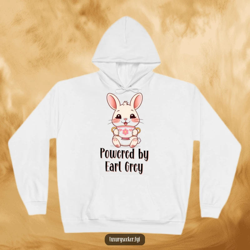 Funny Hoodie featuring a delighted rabbit character holding a tiny, ornate teacup, providing cozy warmth and refined humor.
