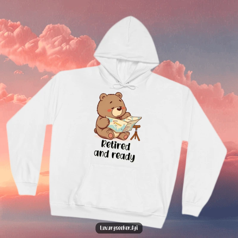 Funny hoodie with a bear intently examining a map, indicating crossed-off luxury vacation spots, symbolizing determination and humor.